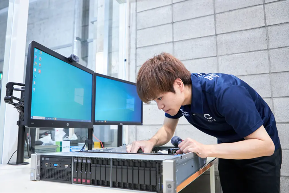 Technician working on server hardware in a data center